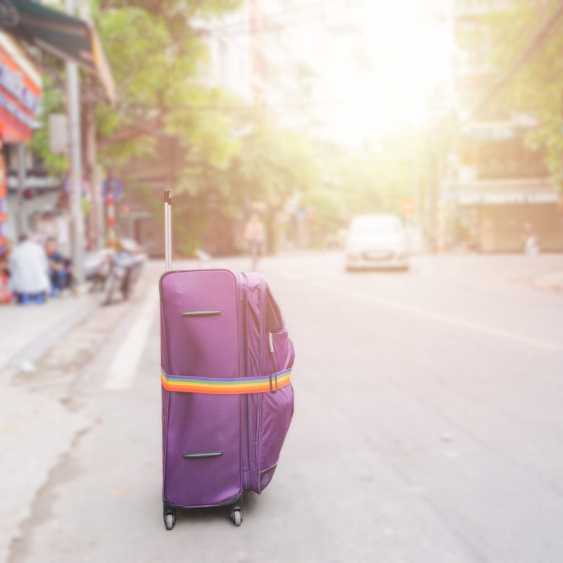 Purple Luggage with rainbow luggage straps