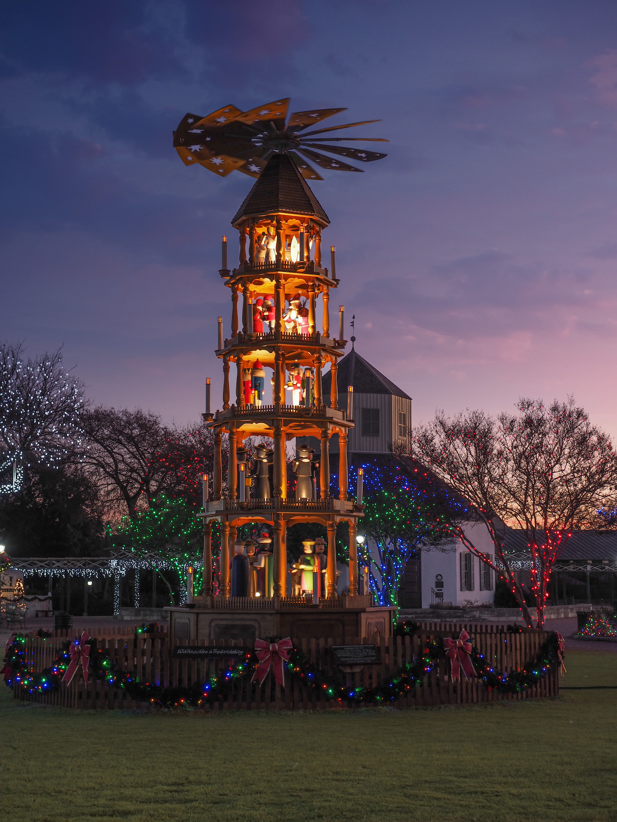 Traditional German Weihnachtspyramide, or Christmas Pyramid lit up at night in Fredericksburg's marketplatz