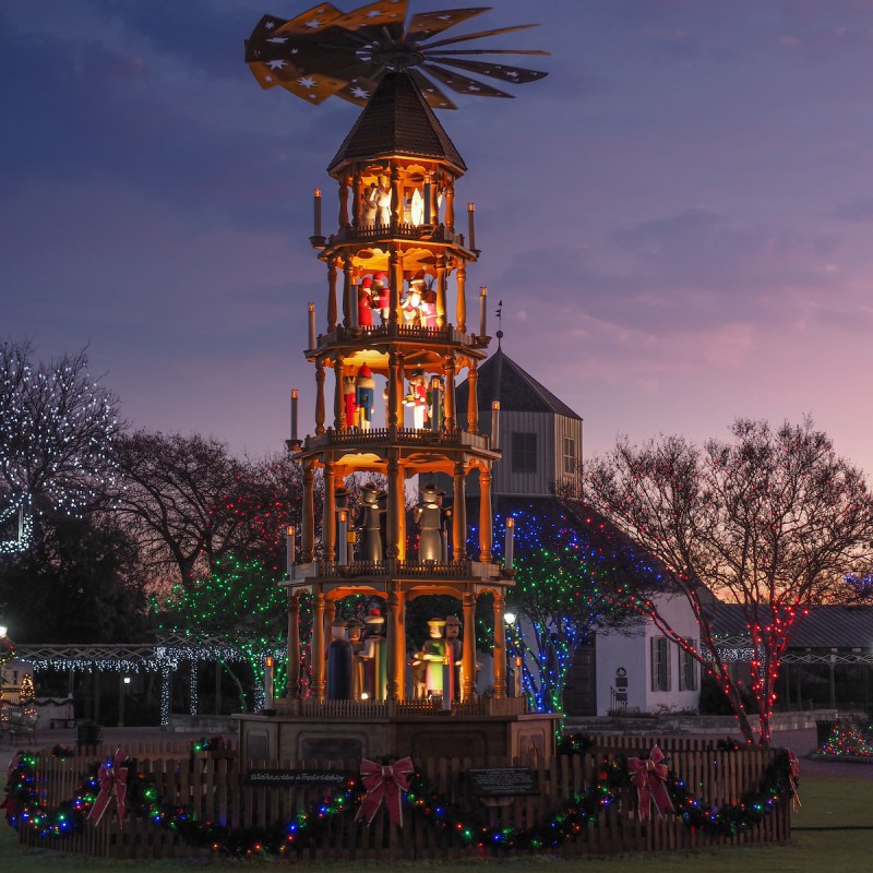 Traditional German Weihnachtspyramide, or Christmas Pyramid lit up at night in Fredericksburg's marketplatz