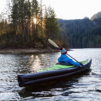 girl on inflatable kayak at dusk