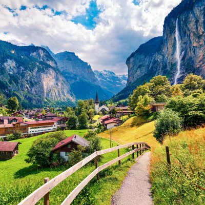 Sunny summer view of great waterfall in Lauterbrunnen village.