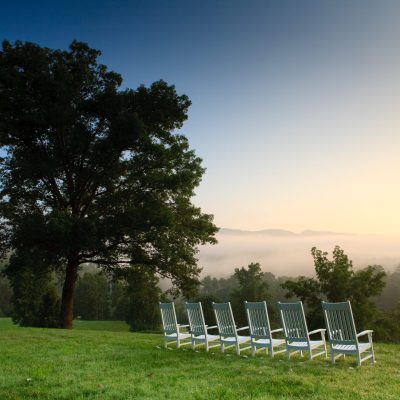 view from the hillside with rocking chairs at Blackberry Farm in Tennessee