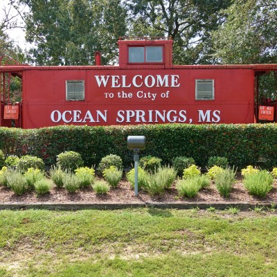 Little red caboose is a rail car with the words “Welcome to the City of Ocean Springs” which sits overlooking Bienville Blvd near the Biloxi Bay Bridge. A symbol of the old L&N railway system.