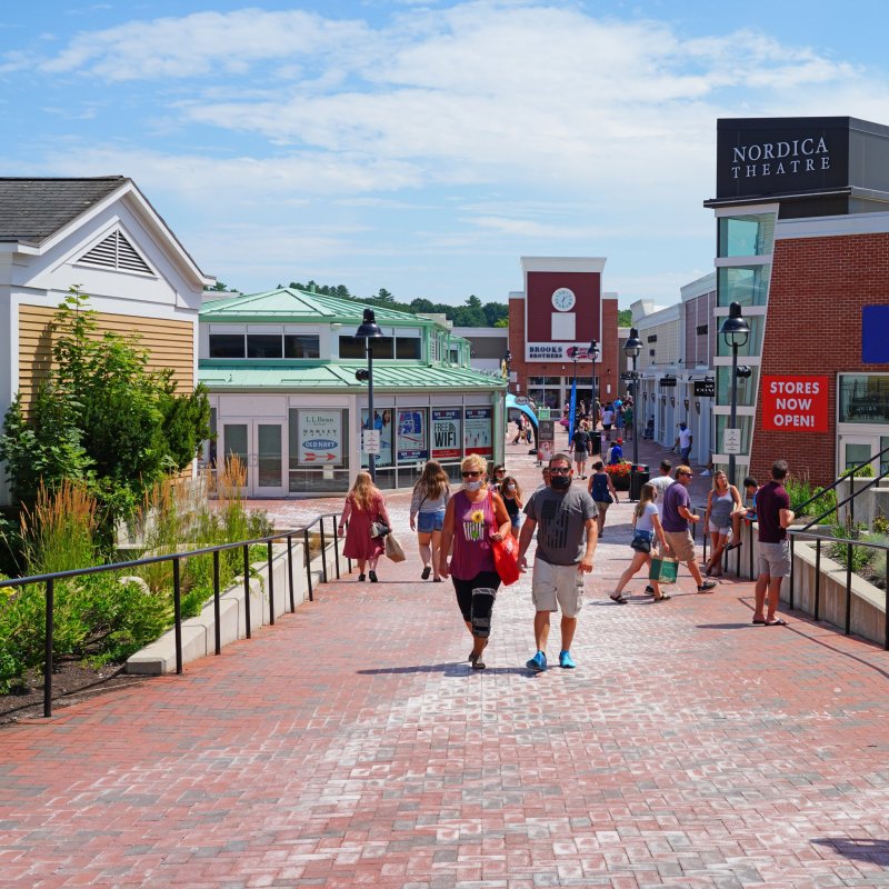 A street of shops and tourists in Freeport, Maine.