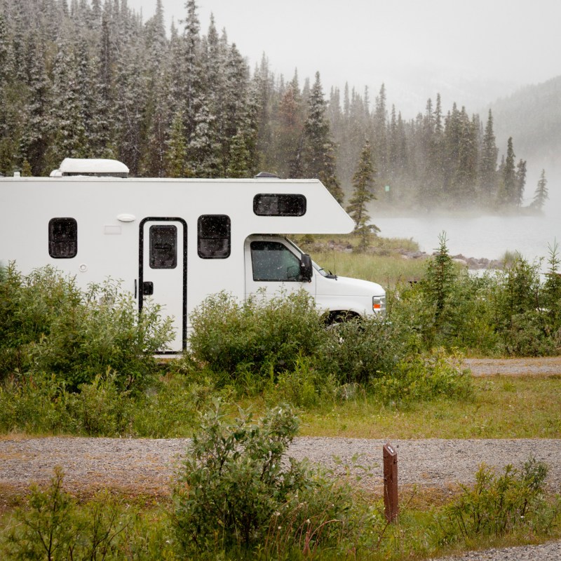 An RV parked alone in the wilderness of Alaska.