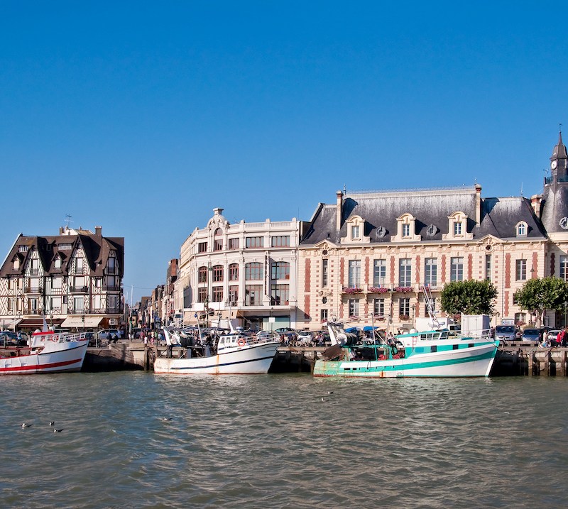 Boats by historic buildings in Trouville, Normandy, France