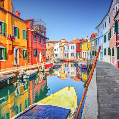 Colorful houses along a canal in Burano, Italy.