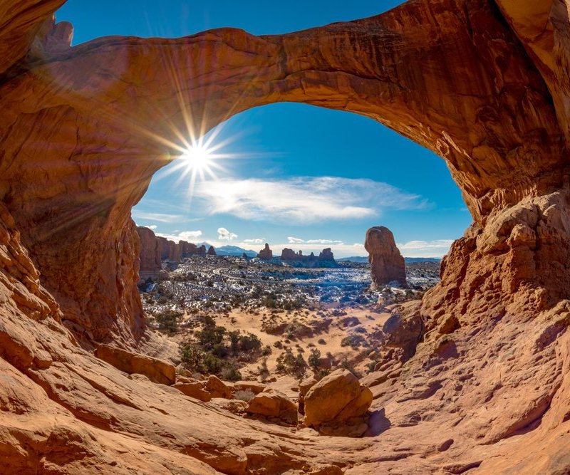 Double Arch in Moab with snow and a sun