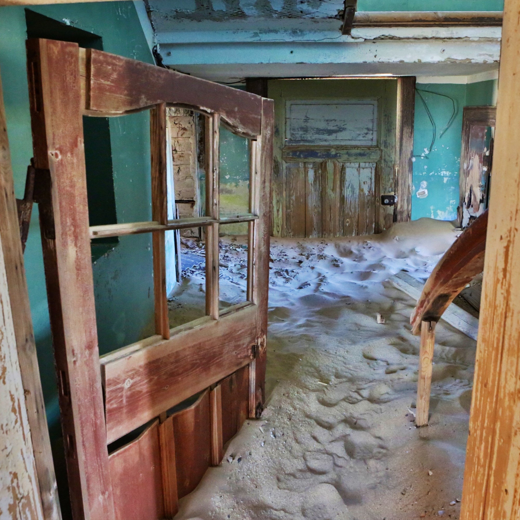 Kolmanskop, Namibia, a ghost town being swallowed by the desert.