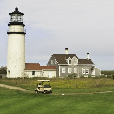 Lighthouse and golf cart in Cape Cod.