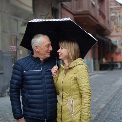 man and woman sharing an umbrella
