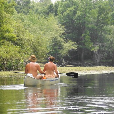 Naturists enjoying a canoe ride.