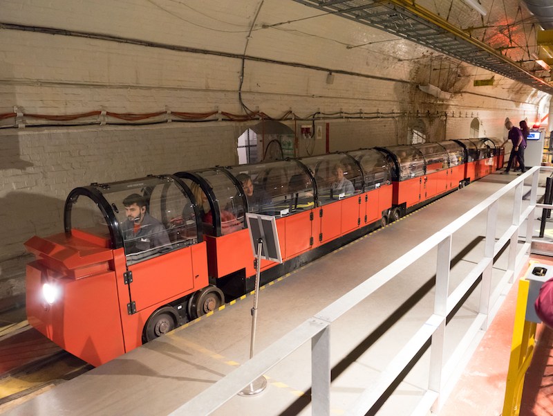 People riding the Mail Rail train in London.