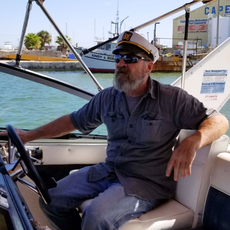 Stuart Bee, 62, navigates his 32-foot Sea Ray through the water.