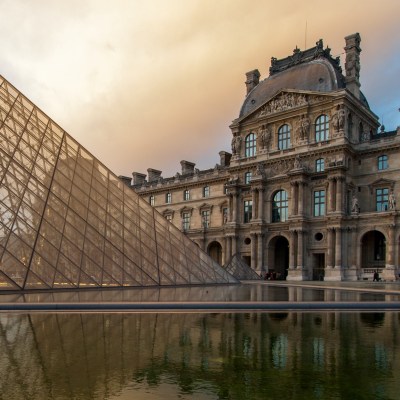 The exterior of the Louvre at sunset.