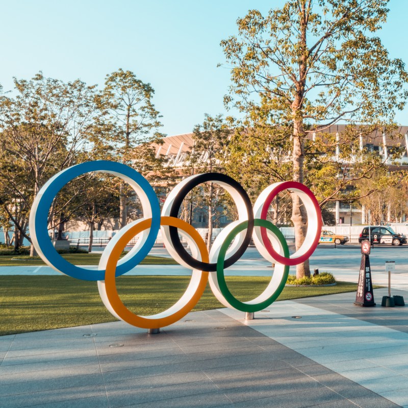 The five-ring symbol of the Olympic Games and view of the New National Stadium