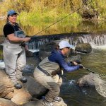 The writer and her friend learning to fly fish.