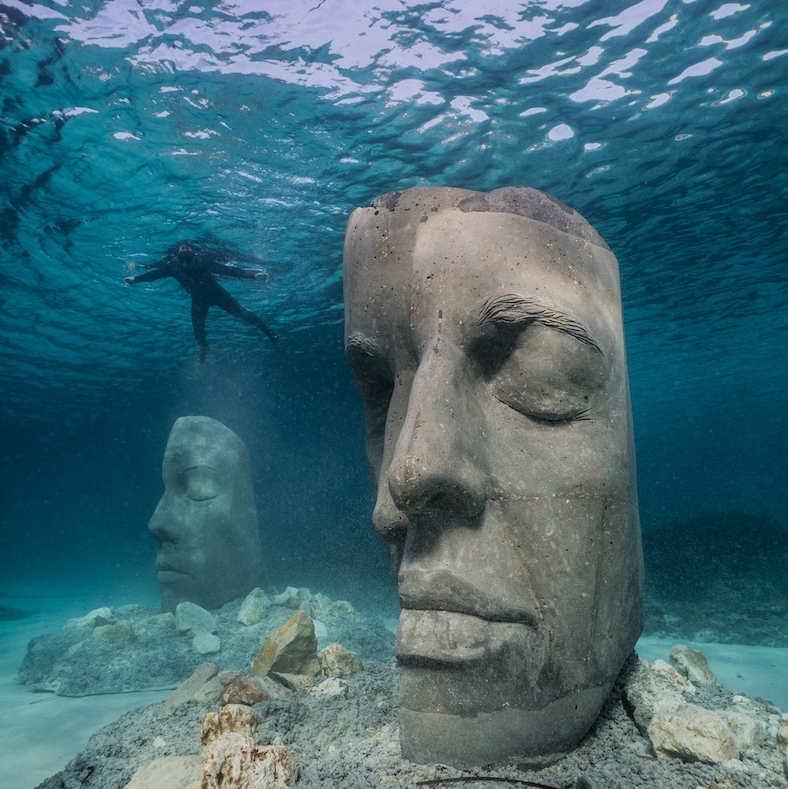 Underwater sculptures with a diver nearby.