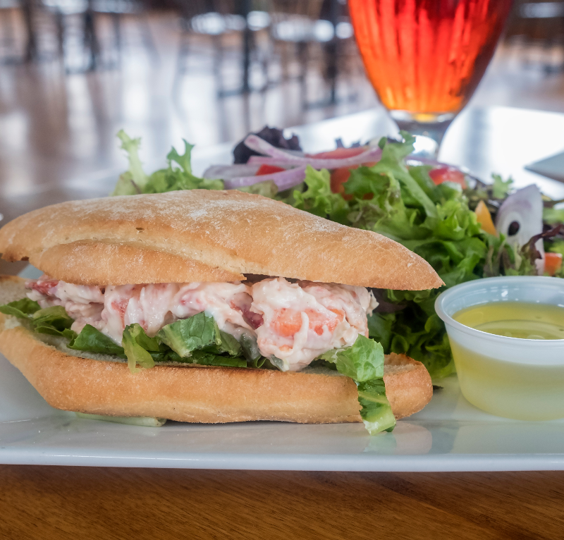 Lobster Roll Served with Fresh Green Salad and Glass of Beer