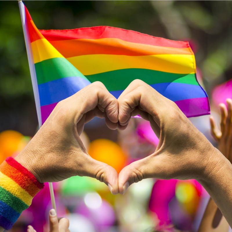 Hands in heart formation at PRIDE parade.