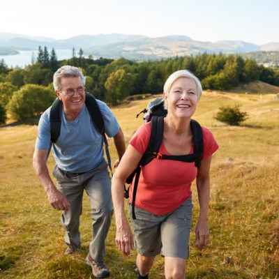 Senior couple in camping gear on hike