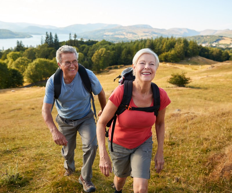 Senior couple in camping gear on hike