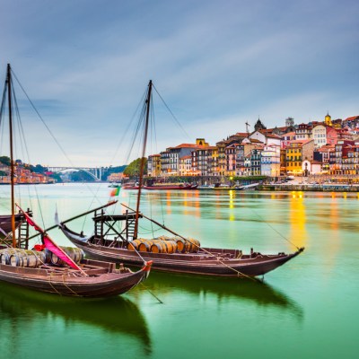 Porto, Portugal old town cityscape on the Douro River with traditional Rabelo boats