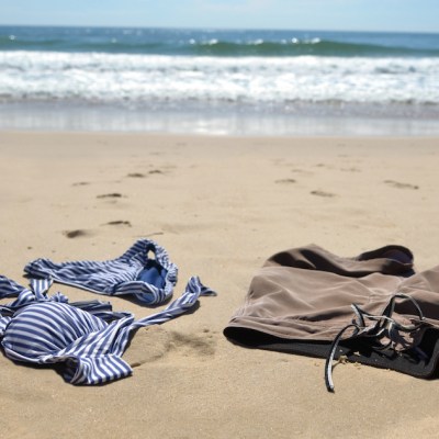 Man and woman's bathing suits on the beach