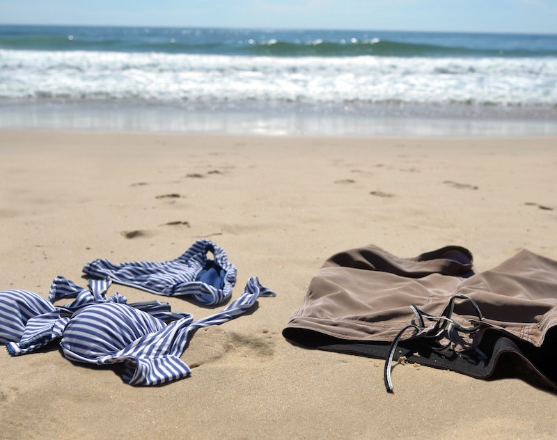 Man and woman's bathing suits on the beach