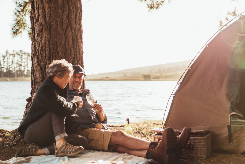 mature couple camping by lake