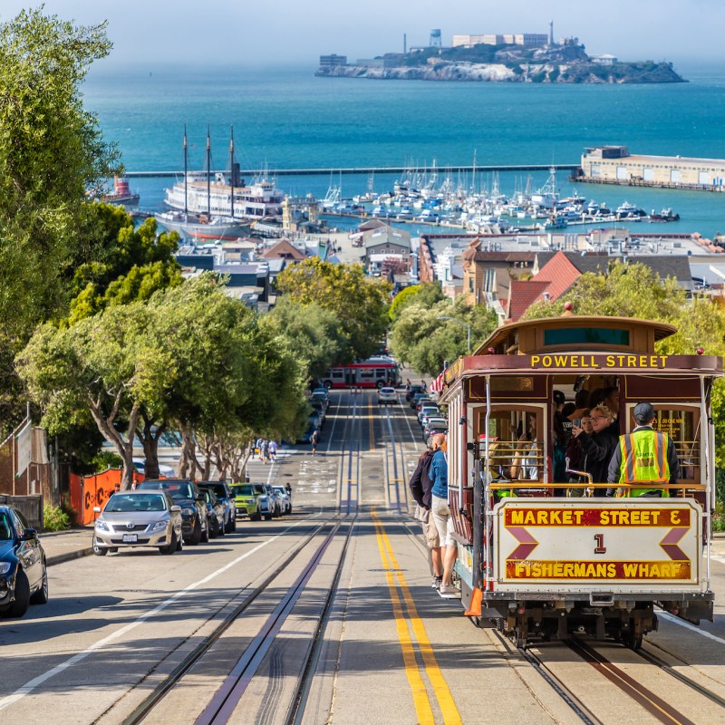 Cable car tram and Alcatraz prison island on a background in San Francisco, California, USA