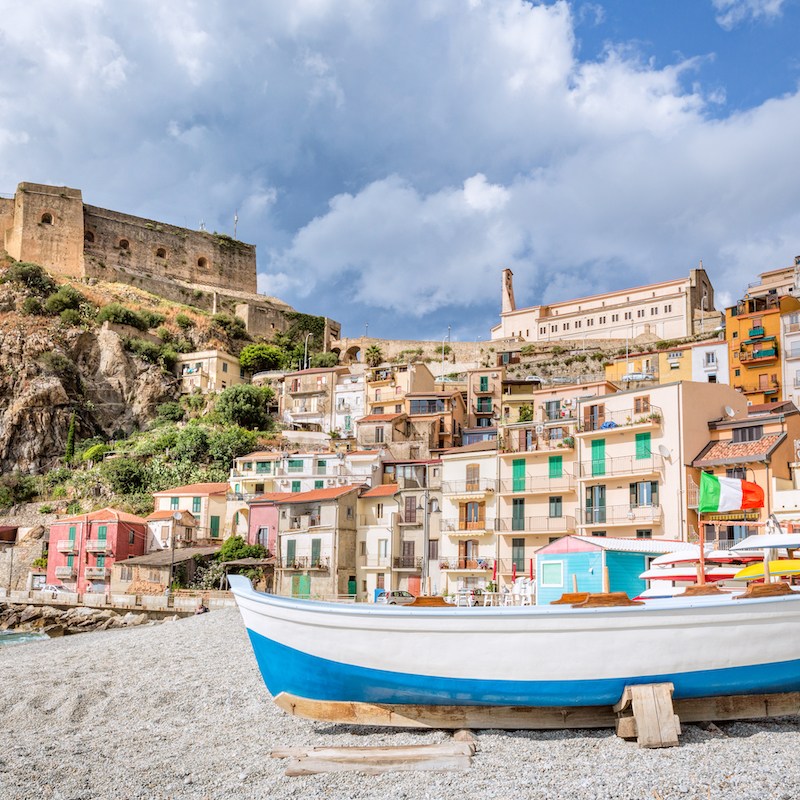 small white and blue fishing boat on the beach in Scilla Calabria
