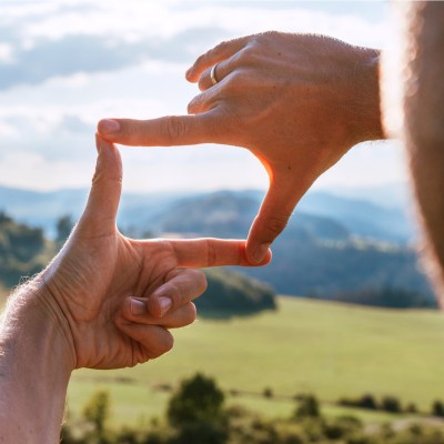 Man choosing photo composition on vacation photo.