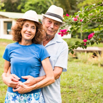 Portrait of a beautiful elderly couple standing embracing outdoors in Costa Rica