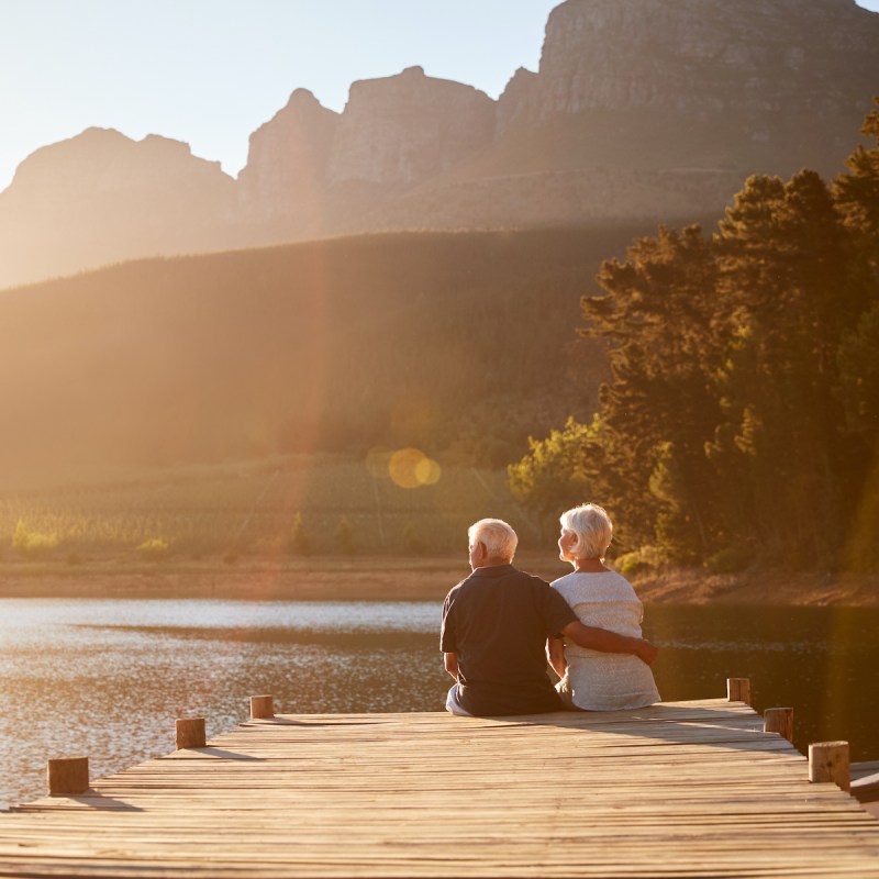 Retired couple sitting on dock