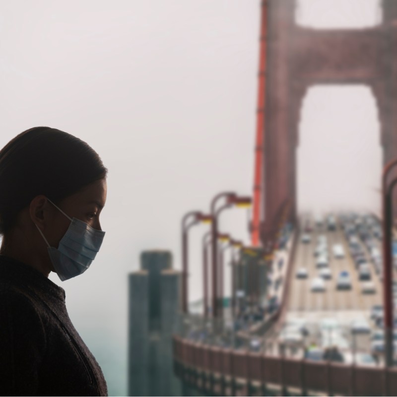 Women with mask near Golden Gate Bridge, San Francisco.