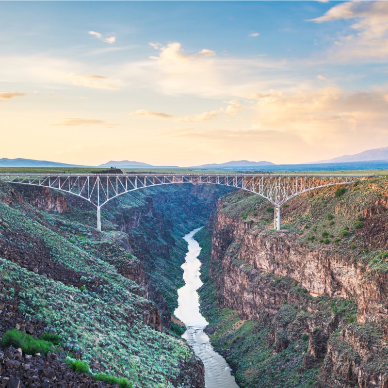 Taos, New Mexico, USA at Rio Grande Gorge Bridge over the Rio Grande at dusk.