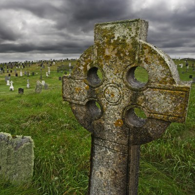 Old Celtic gravesite with unmarked gravestones from the 1600's in the middle of a meadow in rural Scotland.