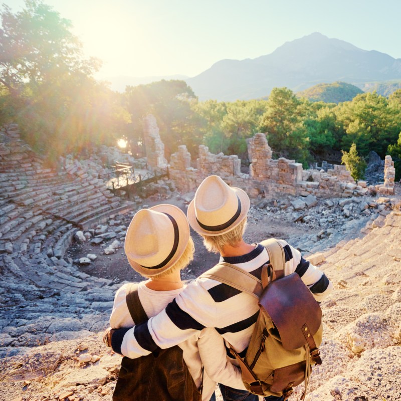 Travel and tourism. Senior family couple enjoying view together on ancient amphitheater.