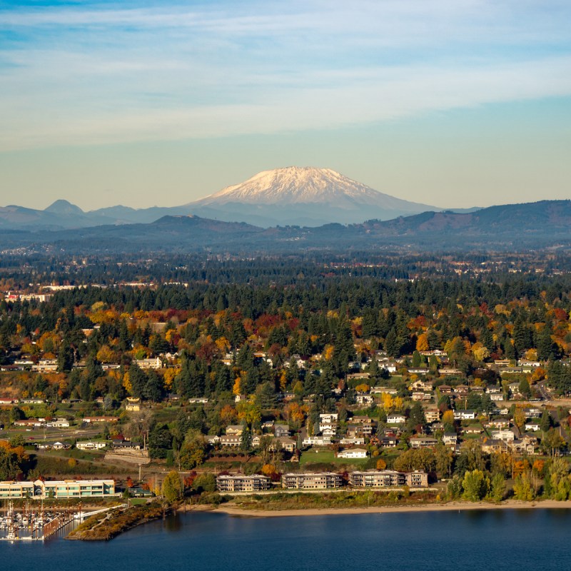 Mt Saint Helens, the columbia river, a boat mooring facility and fall color trees in Vancouver, Washington.
