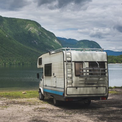 An RV parked on a shoreline