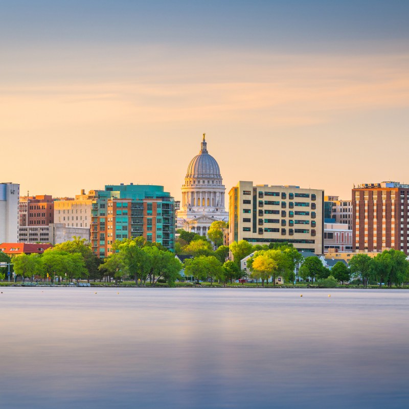 Madison, Wisconsin, USA downtown skyline at dusk on Lake Monona.