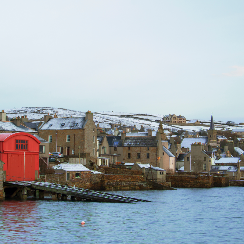 Waterfront view of stone built houses on Orkney islands in winter