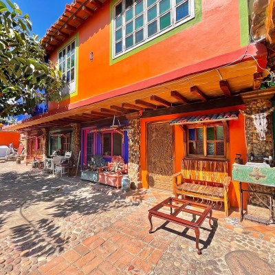 Colorful building exteriors in El Quelite welcome visitors