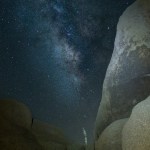 Boulders and Milky Way Galaxy with branch highlighted center foreground.