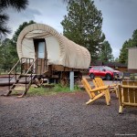 Covered wagon, chairs, and parked vehicle