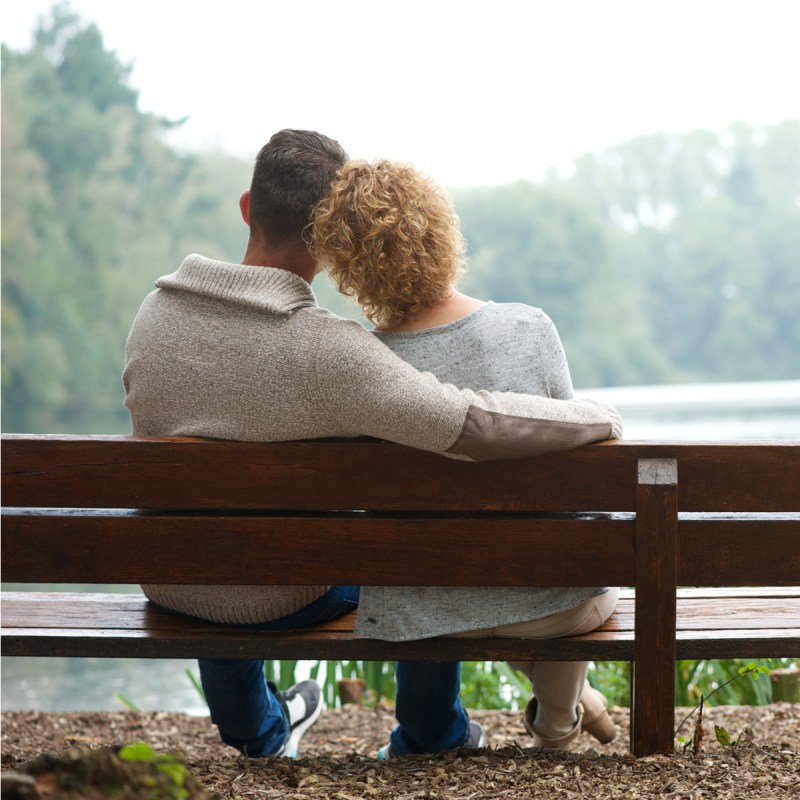 Couple sitting on a bench.