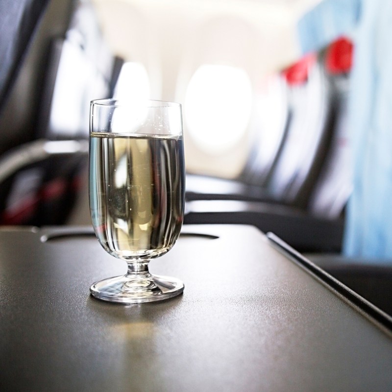Wine glass on plane.