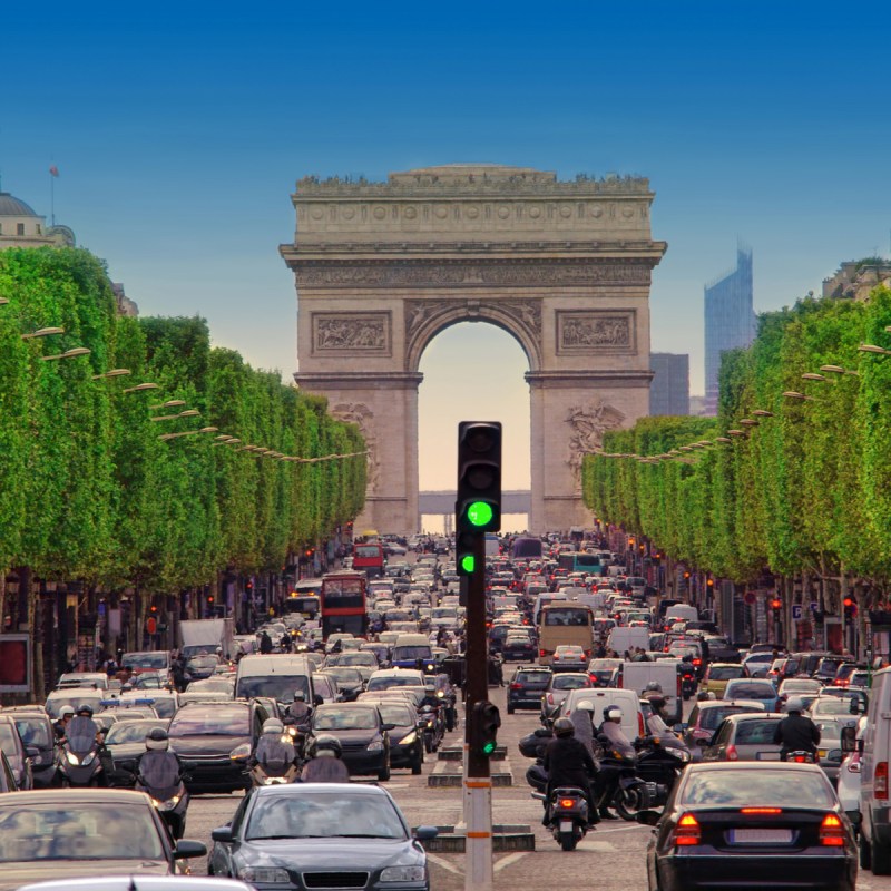 traffic jam with cars in Paris city, France. view of Arc de Triomphe and Champs - Elysees boulevard