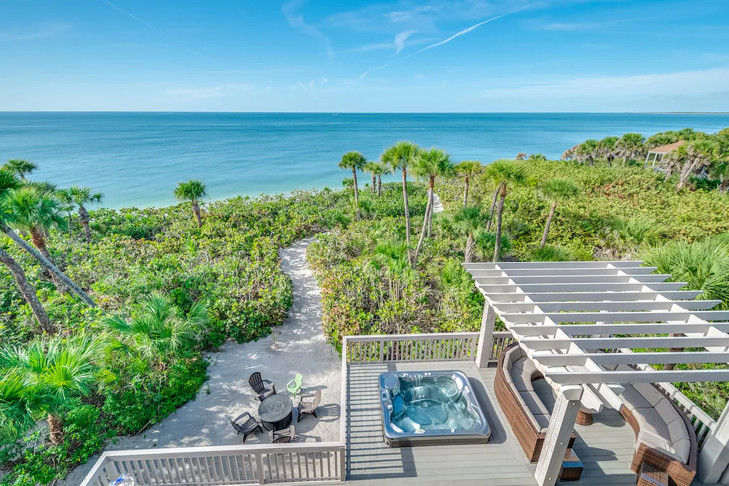 lush, tropical green vegetation surrounding Captiva vacation rental with ocean in the background